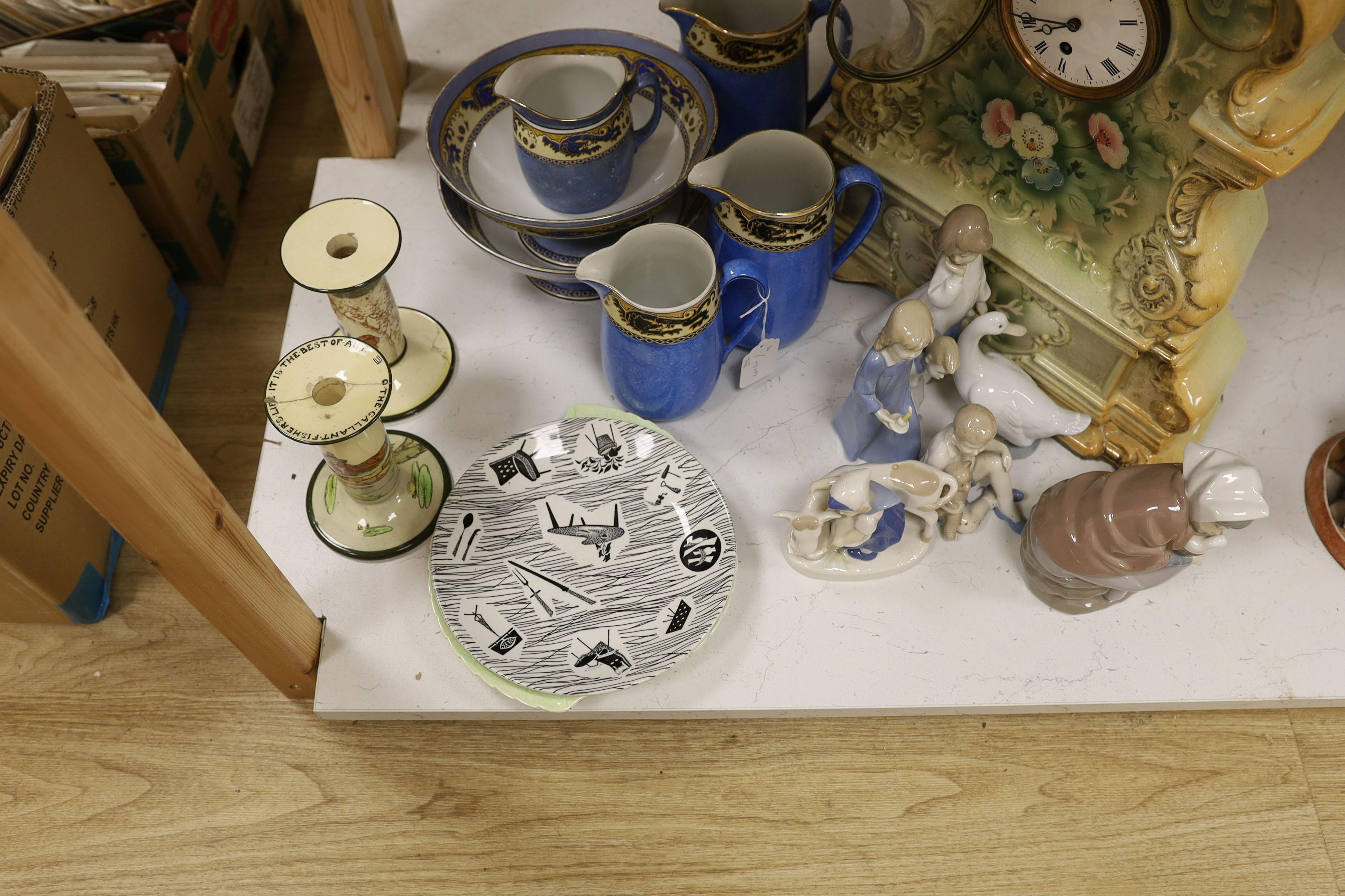 Six mixed Nao and other similar figures, a Homemaker plate, a Carltonware plate, four graduated jugs, and two pedestal bowls, a pair of mottoware candlesticks and a French china mantel clock